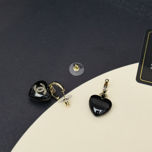 Chanel heart charm earrings, black resin hearts with gold-tone hoops and CC emblem.