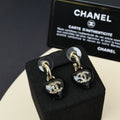 Chanel heart charm drop earrings, black resin with gold-tone CC logo and crystal accents.