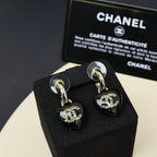 Chanel heart charm drop earrings, black resin with gold-tone CC logo and crystal accents.