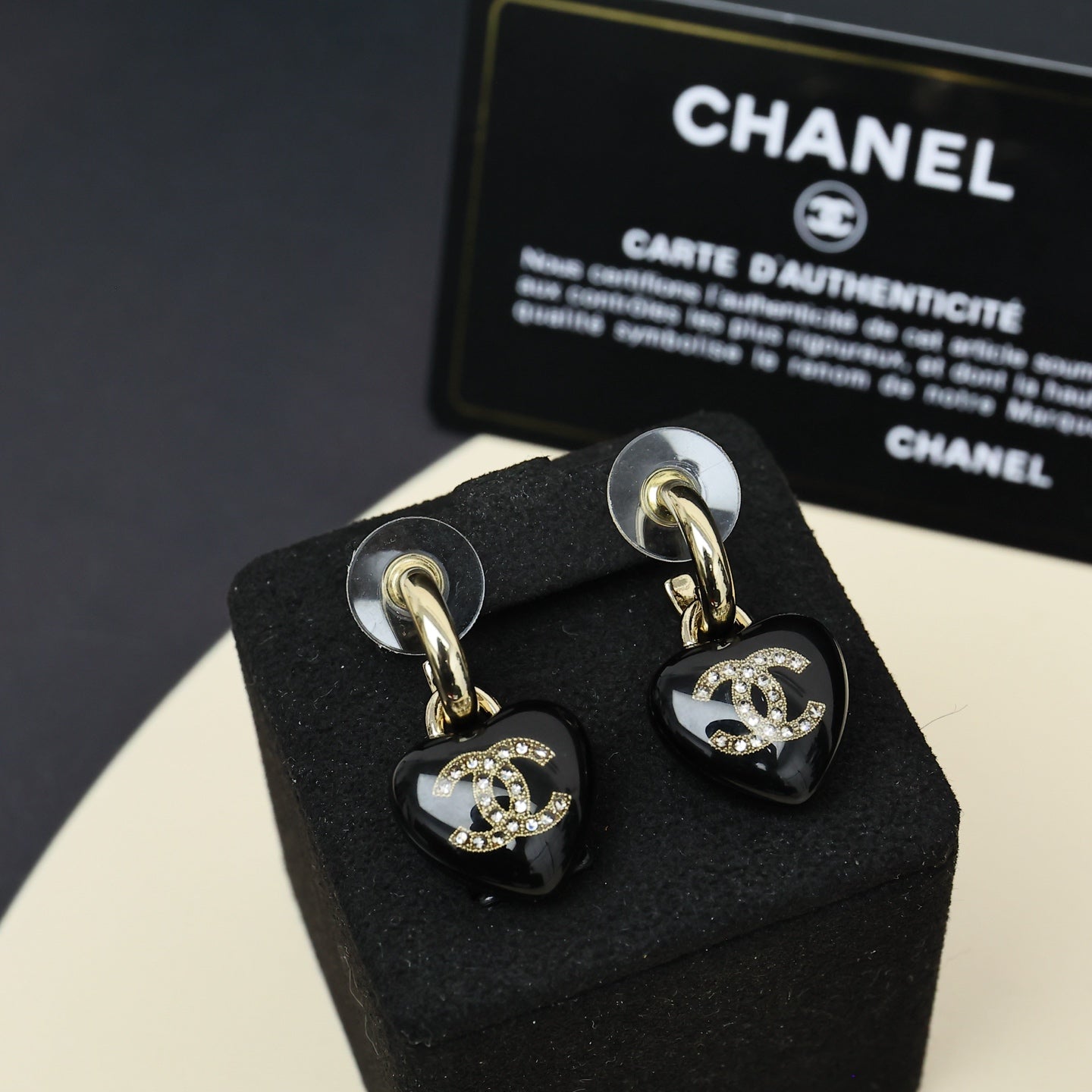 Chanel heart charm drop earrings, black resin with gold-tone CC logo and crystal accents.