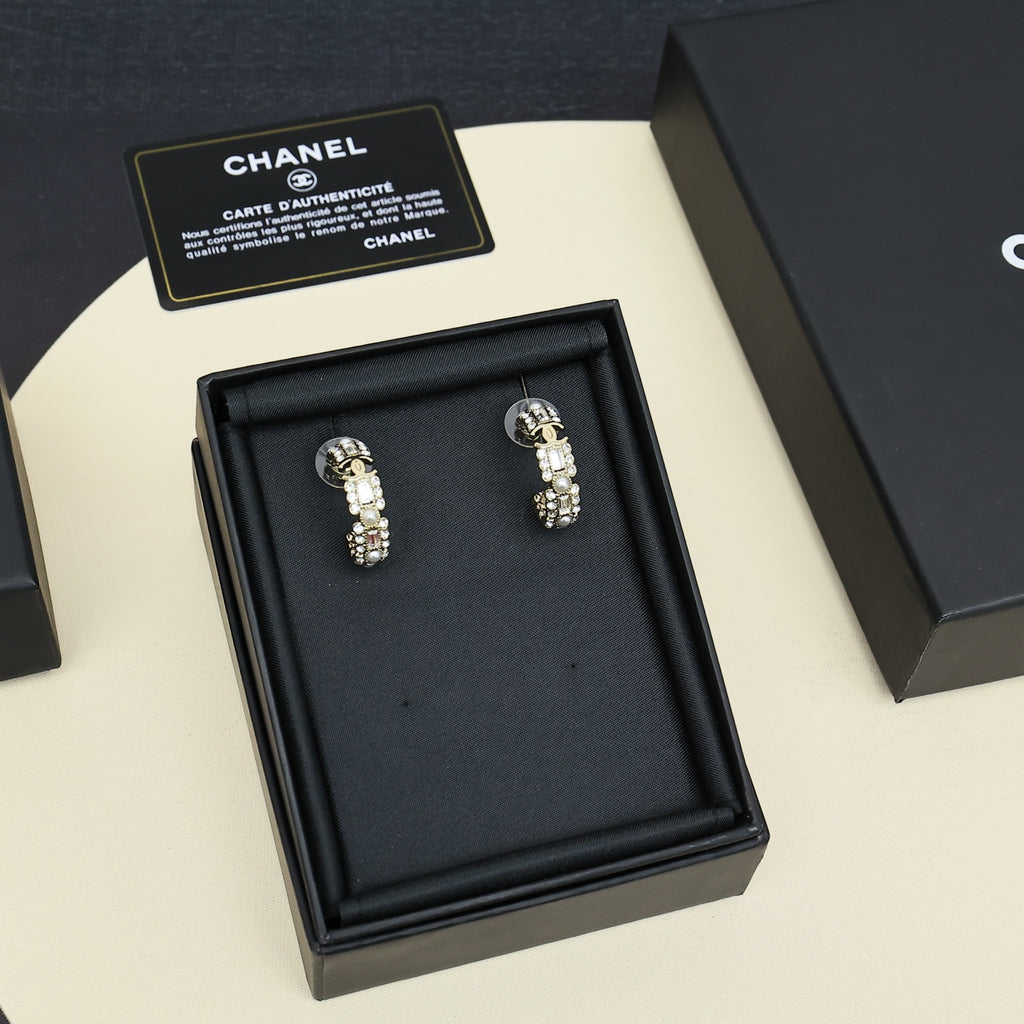 Gold-tone hoop earrings with pearl and rhinestone accents, displayed in black gift box.
