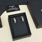 Gold-tone hoop earrings with pearl and rhinestone accents, displayed in black gift box.