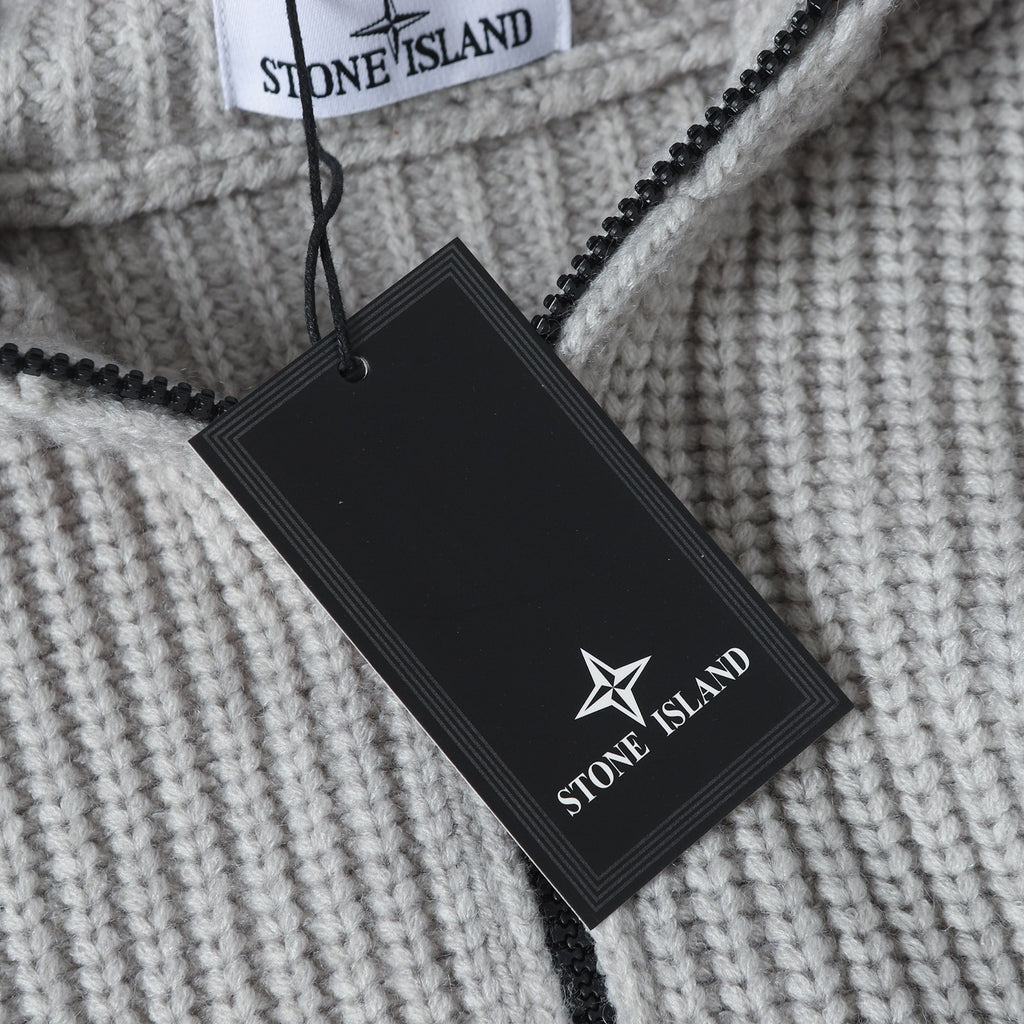Light gray knit hoodie with black Stone Island hang tag and zipper near hood