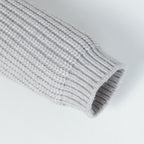 Stone Island knitwear cuff end on light gray ribbed sleeve