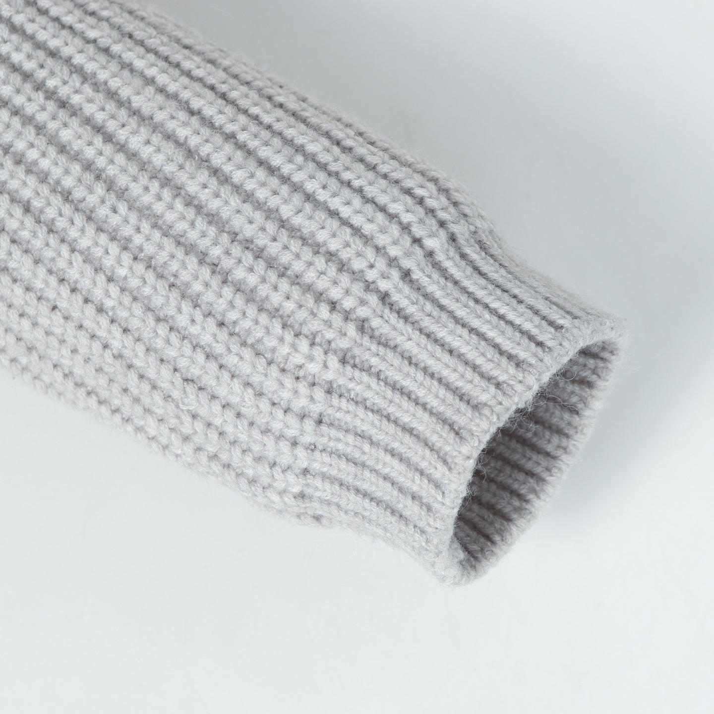 Stone Island knitwear cuff end on light gray ribbed sleeve