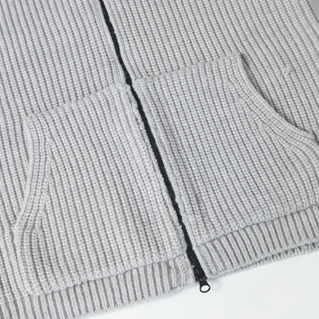 Light gray knit hoodie front with black zipper and ribbed waistband