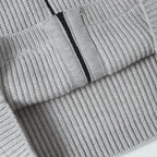 Light gray knit hoodie sleeve cuff with ribbed cuff detail and zipper edge
