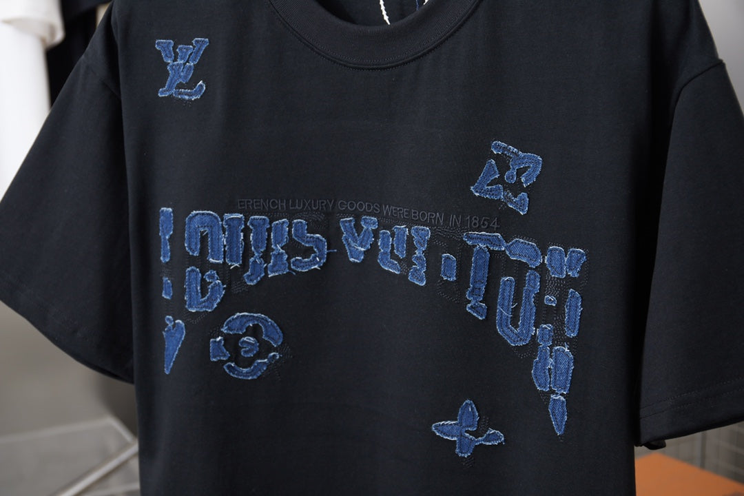Louis Vuitton black T-shirt with blue LV logo and icon graphic across chest