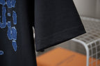 Louis Vuitton black T-shirt with stitched hem and blue graphic print corner