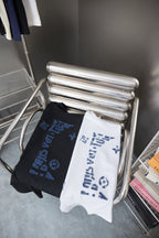 Louis Vuitton folded T-shirts on rack: black and white with blue LV logo print