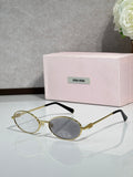 MiuMiu oval eyeglasses with gold-tone metal frame, black temple tips, clear lenses