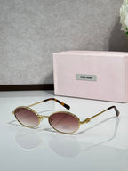 MiuMiu oval eyeglasses with gold-tone metal frame, black temple tips, rose-tinted lenses
