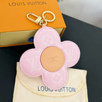 Louis Vuitton pink flower keychain with gold clasp and beige center patch