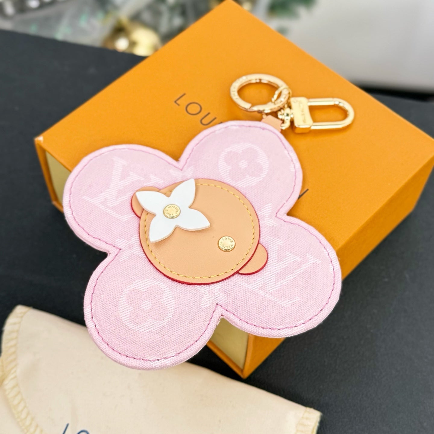 Louis Vuitton pink flower keychain charm with beige center and gold keyring loop