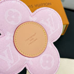 Louis Vuitton pink flower keychain close-up of beige center with LV logo