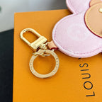 Louis Vuitton pink flower keychain with gold keyring and clasp on accessory tag