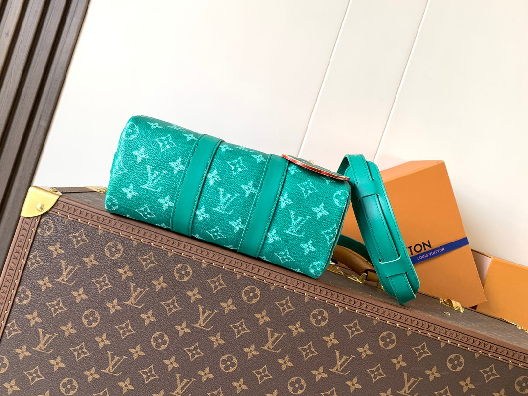 Louis Vuitton green monogram flap-style bag with teal shoulder strap