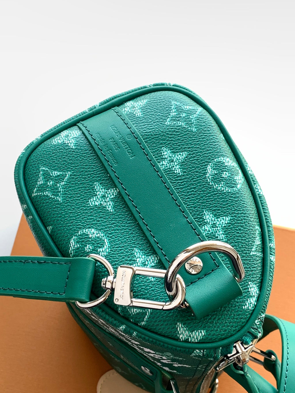 Louis Vuitton green monogram bag with silver D-ring hardware and strap