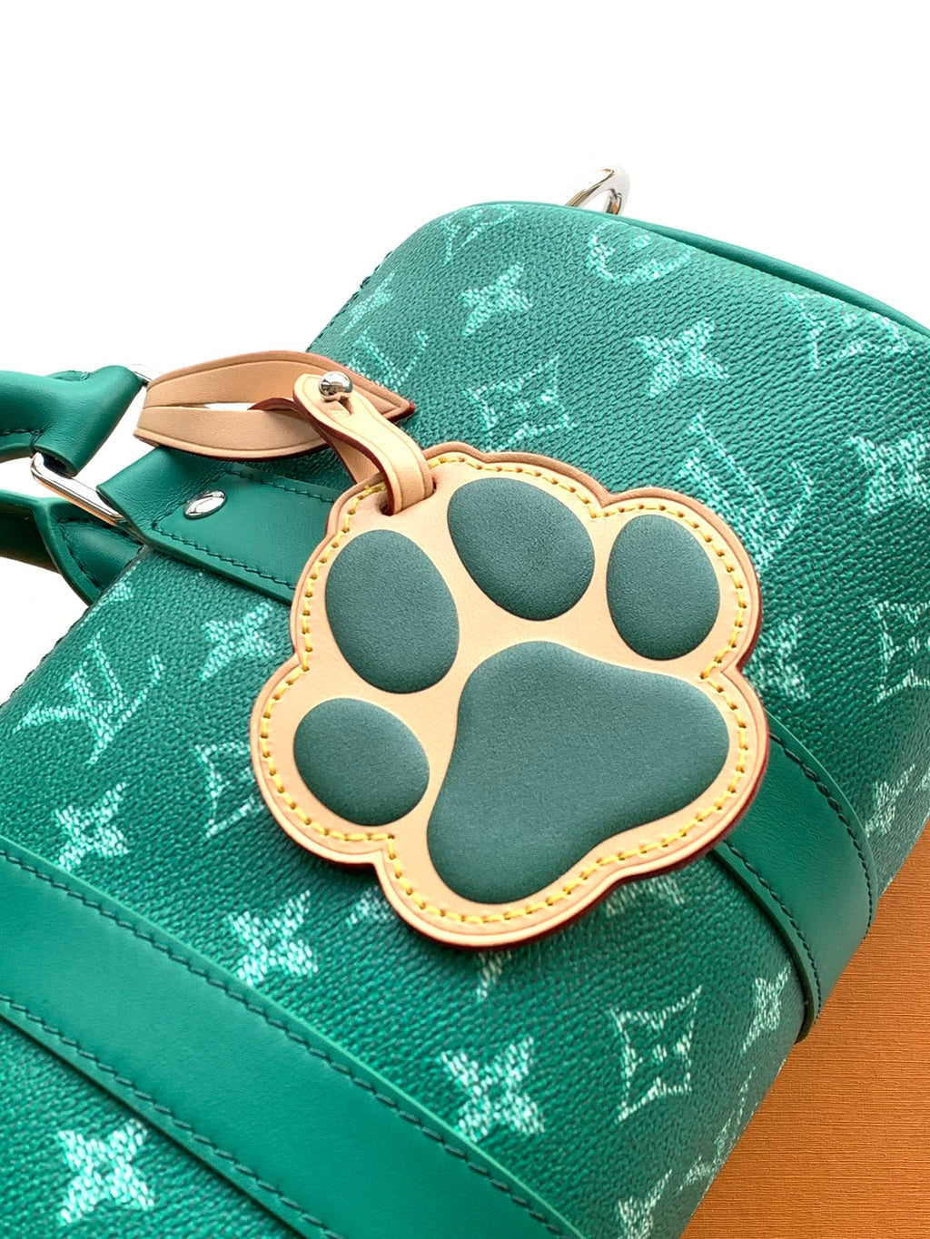 Louis Vuitton green monogram bag with paw-shaped leather charm patch