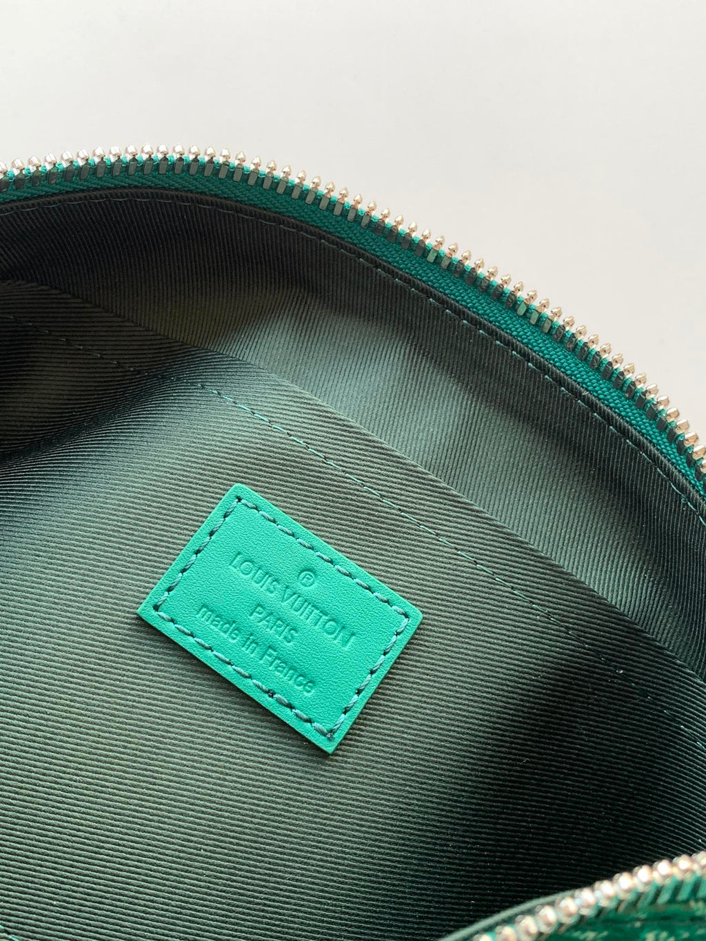 Louis Vuitton green interior pocket tag on monogram bag