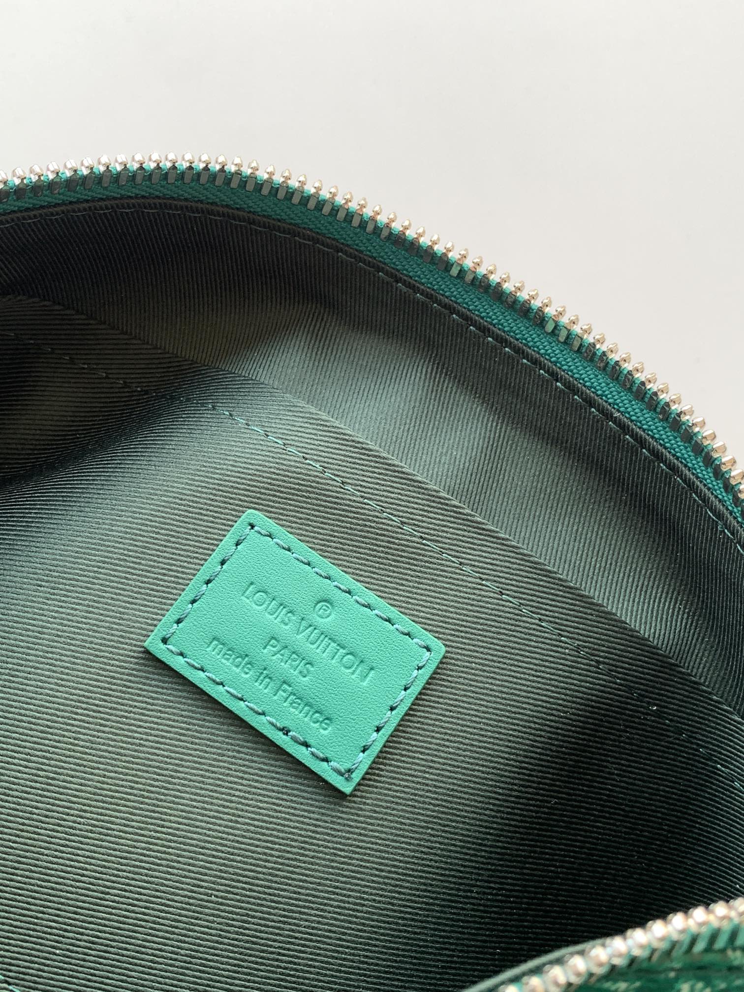 Louis Vuitton green interior pocket tag on monogram bag