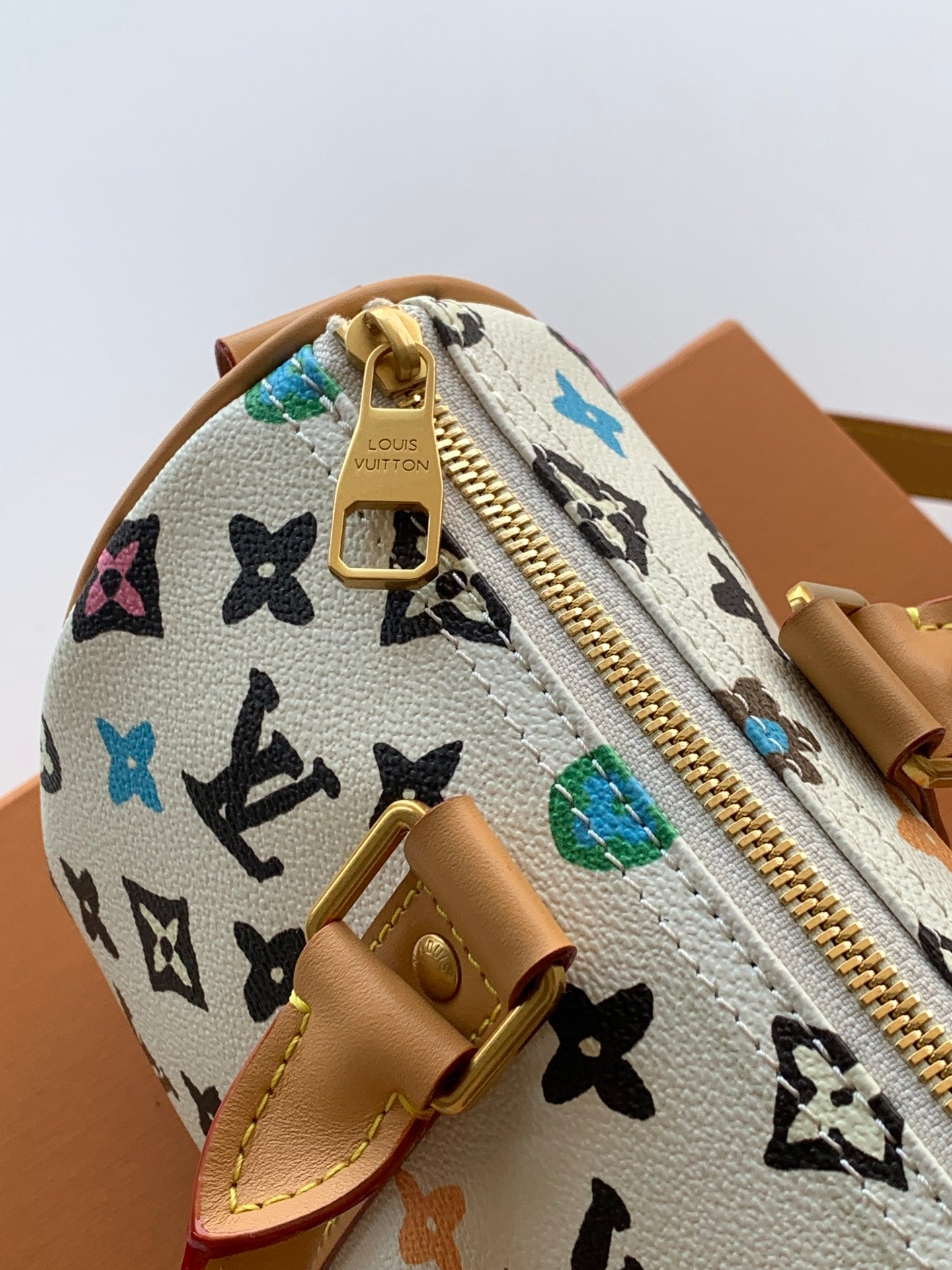 Louis Vuitton mini handbag close-up of top zip and multicolor monogram pattern