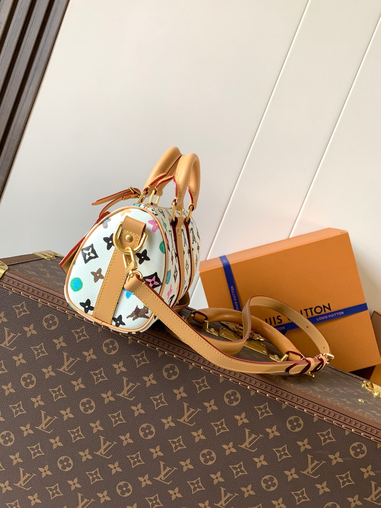 Louis Vuitton mini handbag with tan top handles and multicolor monogram side view