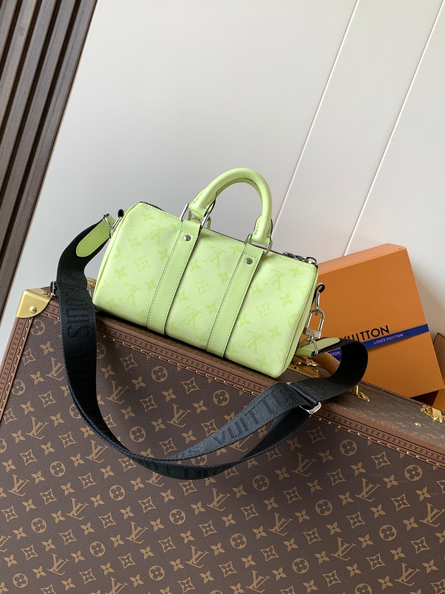Louis Vuitton green leather handbag with front details and crossbody strap