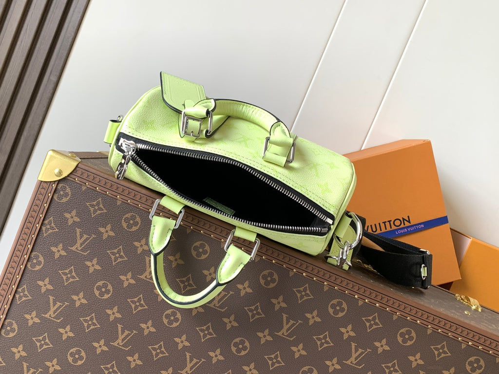 Louis Vuitton green leather handbag with zipper top and attached shoulder strap