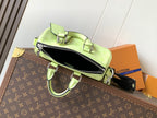Louis Vuitton green leather handbag with zipper top and attached shoulder strap