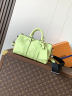 Louis Vuitton green leather handbag with top handles and shoulder strap
