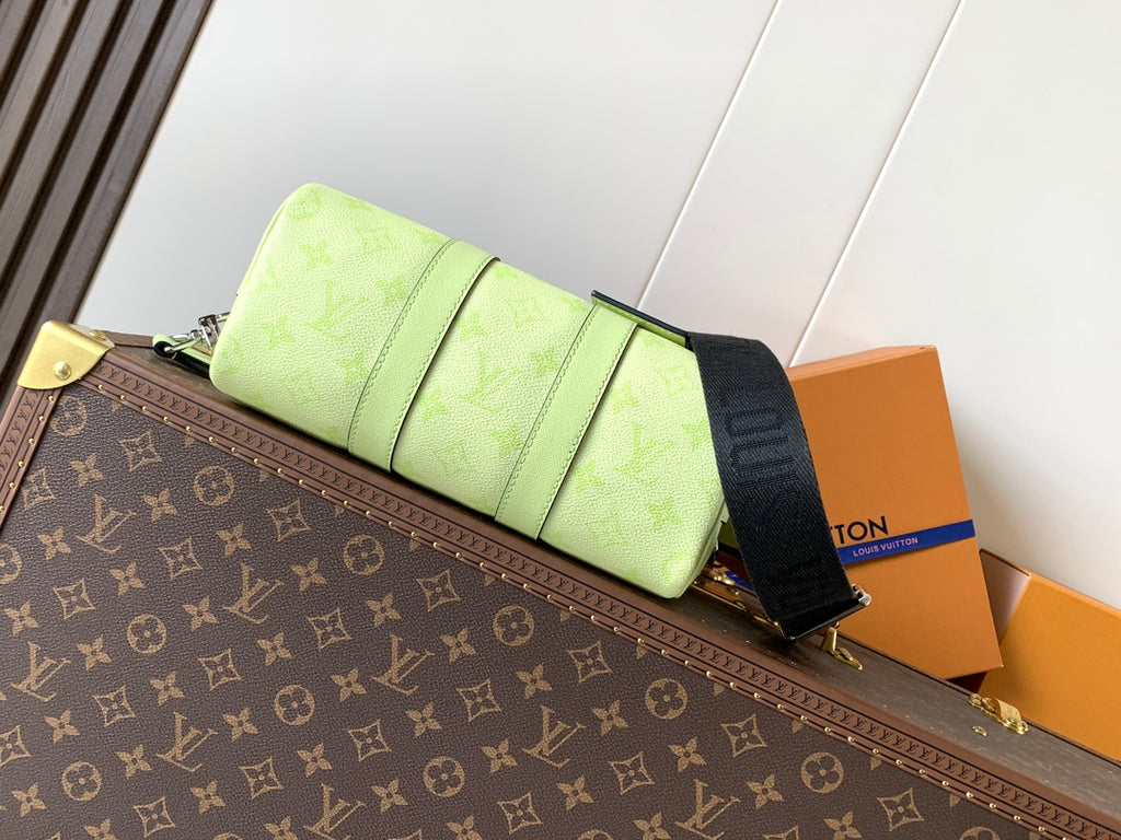 Louis Vuitton green leather handbag side view with strap and folded panel detail