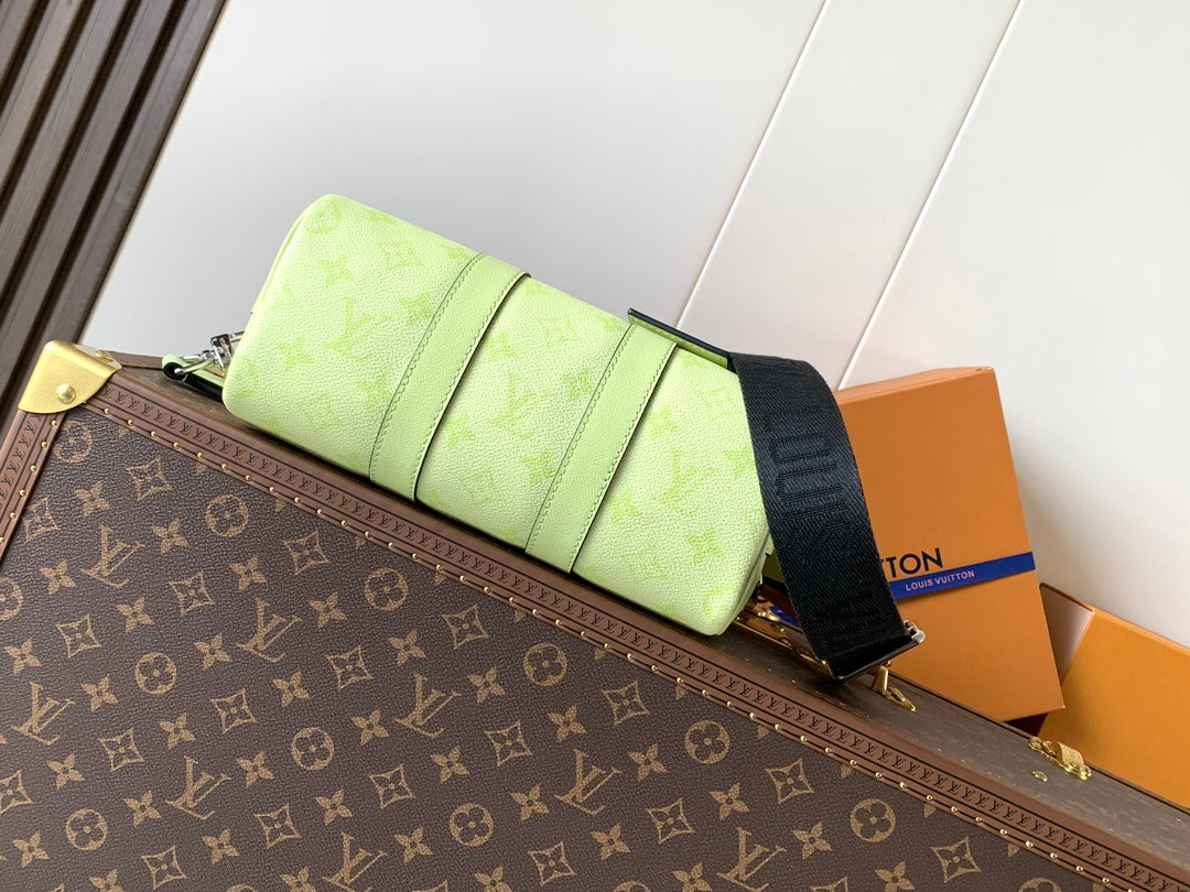 Louis Vuitton green leather handbag side view with strap and folded panel detail