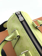 Louis Vuitton green leather bag detail with zipper track and side hardware