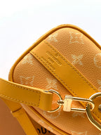 Louis Vuitton monogram crossbody bag with stitched leather trim and metal ring