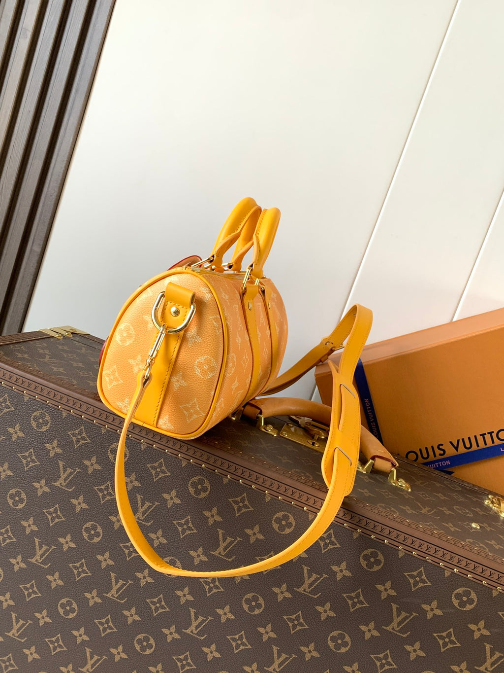 Louis Vuitton monogram bag with yellow crossbody strap and top handles