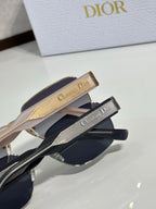 Sunglasses close-up with gold and navy temples featuring Christian Dior text