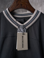 Balenciaga black T-shirt neckline with striped trim and Balenciaga hang tag