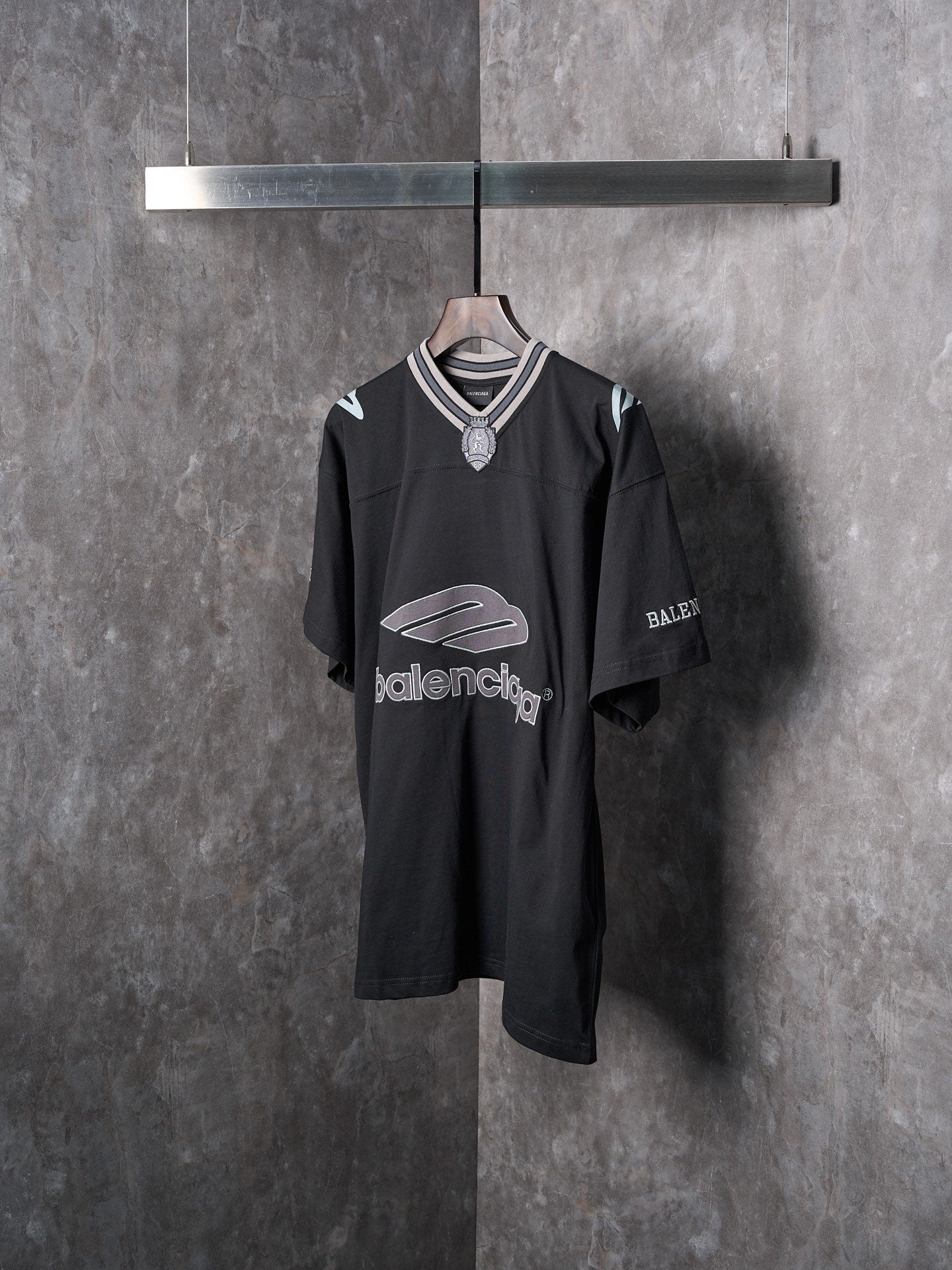 Balenciaga black short-sleeve T-shirt with shield emblem at neckline and logo print