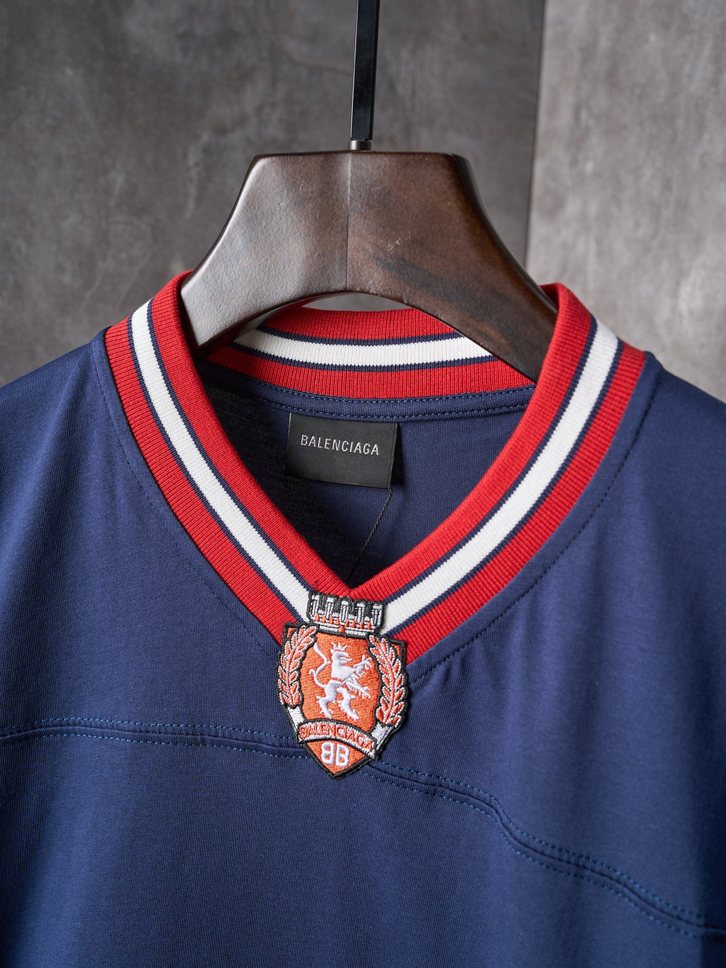 Balenciaga navy jersey collar with red and white rib trim and crest emblem