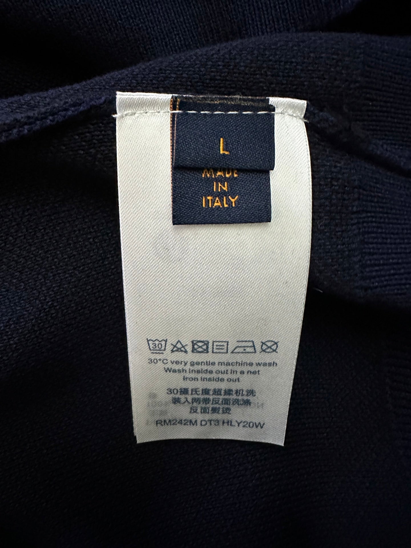 Inside neck label on Louis Vuitton sweater: size and care text