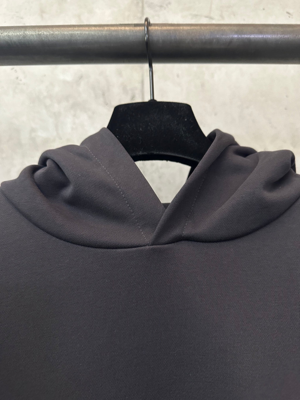 Black hoodie hood and neckline with ribbed texture, close-up