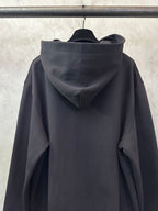Black long-sleeve hoodie with hood and relaxed sleeves, back view