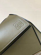 Loewe leather bag corner close-up with embossed logo and contrast stitching