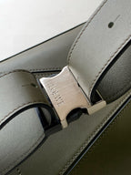 Loewe leather bag strap detail with gold-toned buckle and debossed logo plate