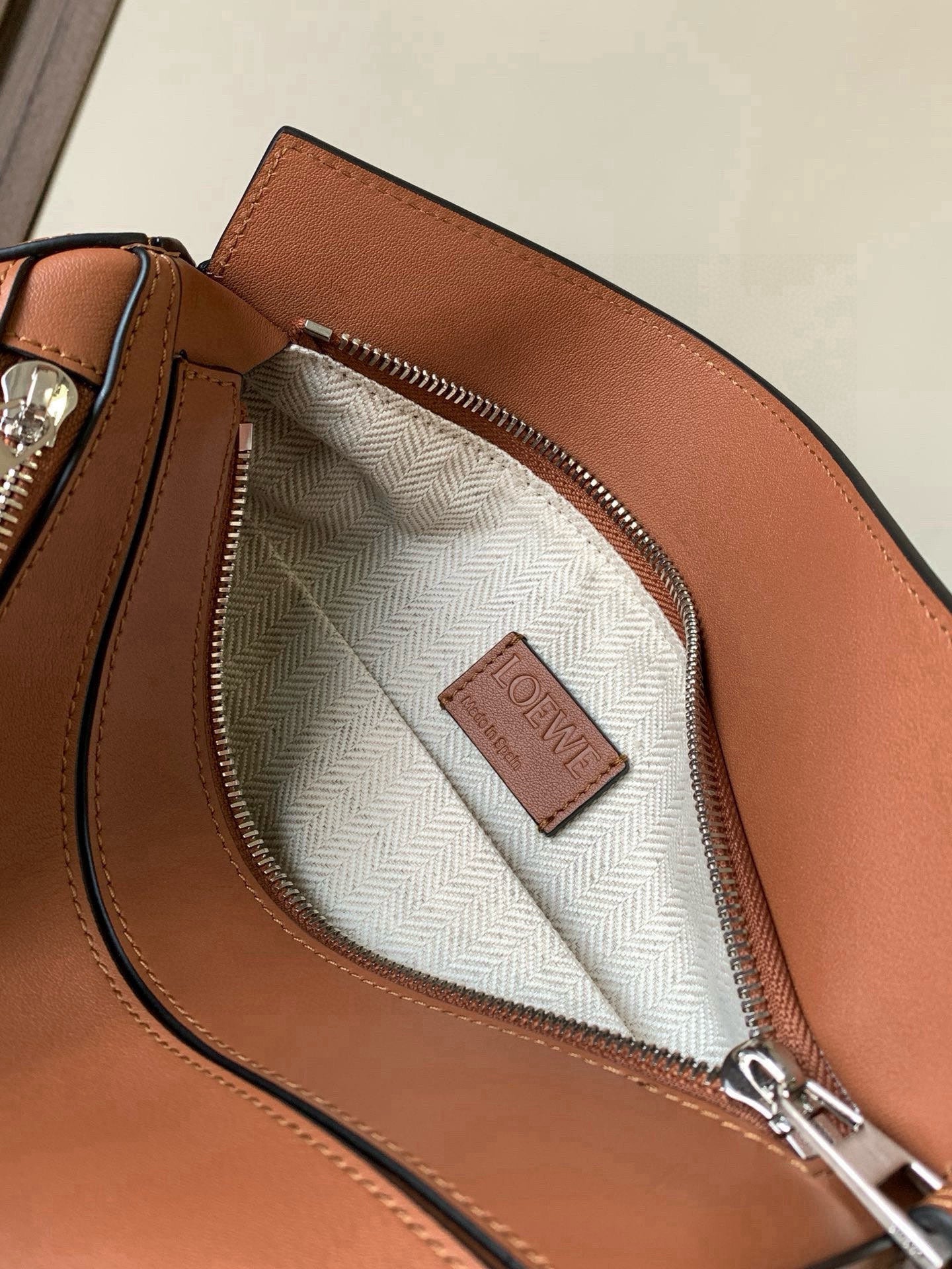 Loewe peach leather bag interior with herringbone lining and Loewe patch