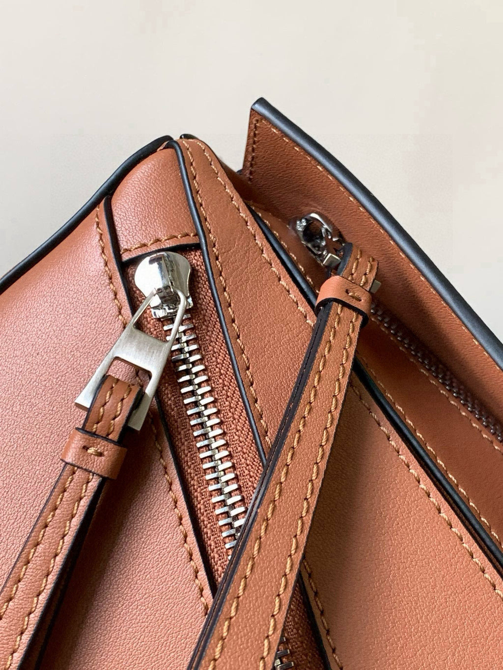 Loewe peach leather bag close-up of zipper pull and interior seam stitching
