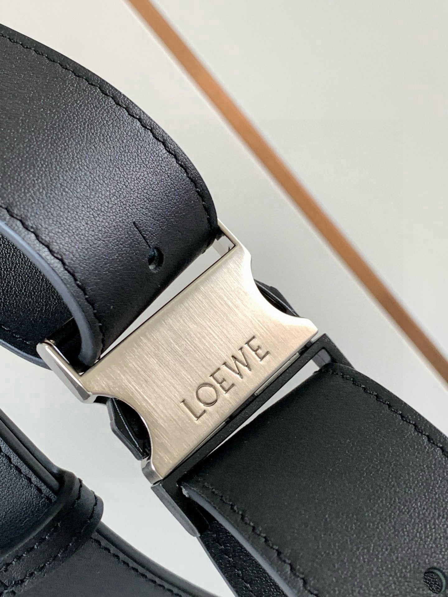 Loewe leather crossbody bag buckle with metal LOEWE logo plate and stitched strap