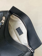 Loewe dark blue leather bag interior with patterned lining and zip pocket