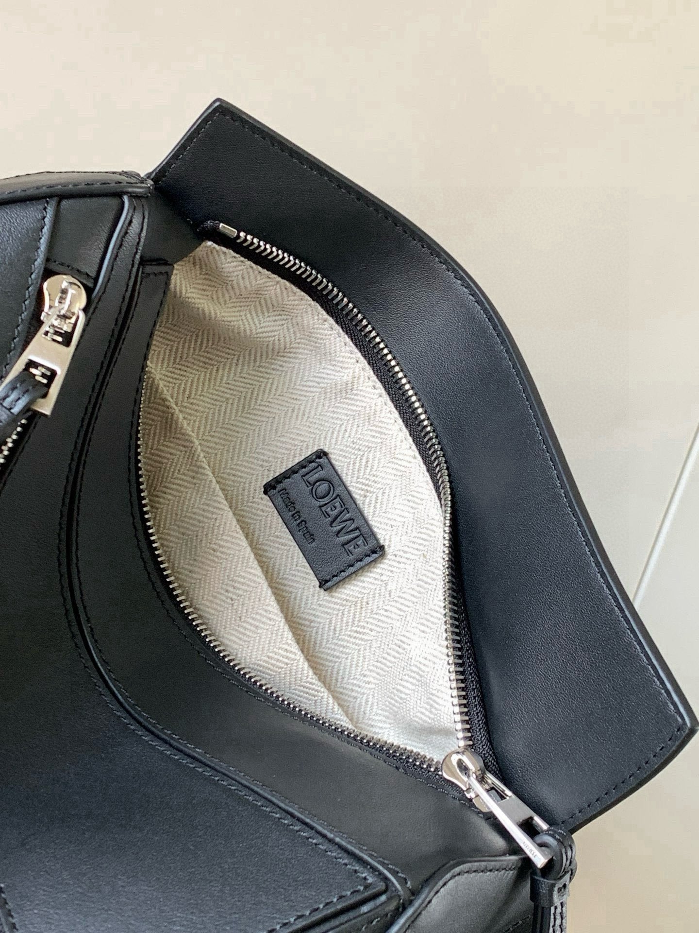 Loewe dark blue leather bag interior with patterned lining and zip pocket